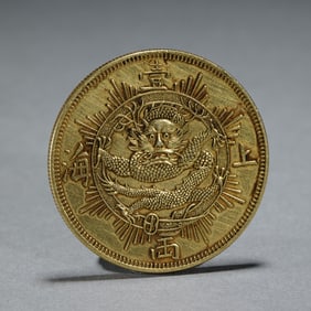 A SILVER-GILT DRAGON COIN