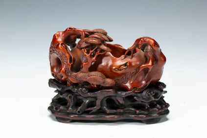 A CARVED ANATTO-WOOD WASHER
