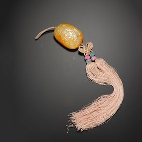 A CARVED JADE PENDANT