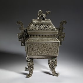 A SILVER INCENSE BURNER WITH COVER
