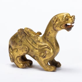 A BRONZE-GILT MYTHICLA BEAST BIXIU