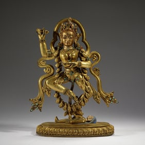 A TIBETAN BRONZE-GILT DAKINI
