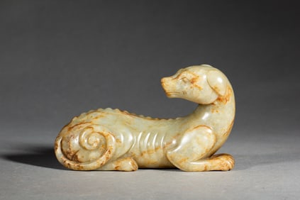 A CARVED WHITE JADE HOUND