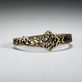 A TIBETAN IRON AND GILT BANGLE