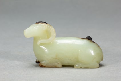 A CARVED WHITE JADE RAM