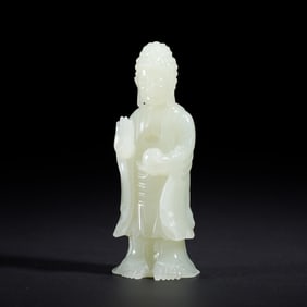A CARVED WHITE JADE STANDING GUANYIN