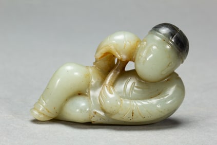 A CARVED WHITE JADE BOY