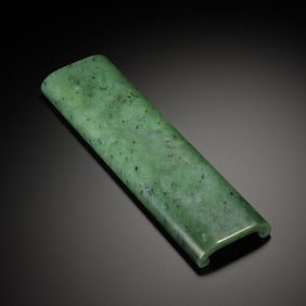 A SPINACH GREEN JADE ARM-REST