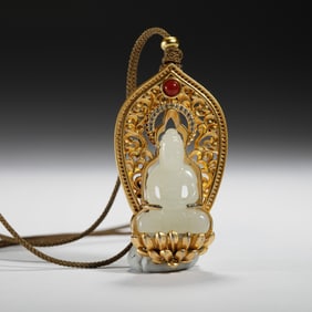 A CARVED WHITE JADE AMITABHA PENDANT