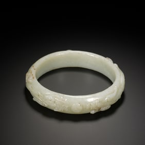 A CARVED WHITE JADE CHILONG BANGLE