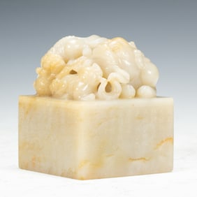 A CARVED WHITE JADE BEAST SEAL