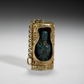 A CARVED TURQUOISE LUOHAN WITH SILVER-GILT SHRINE