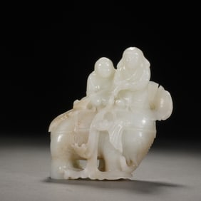 A CARVED WHITE JADE BOYS ON ELEPHANT