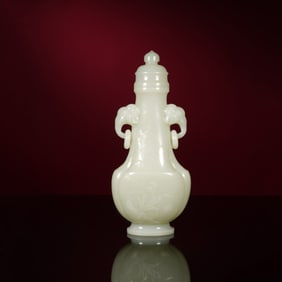 A CARVED WHITE JADE VASE WITH COVER