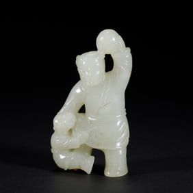 A CARVED WHITE JADE BOY WITH BALL
