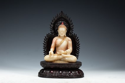 A CARVED SHOUSHAN STONE SEATED BUDDHA