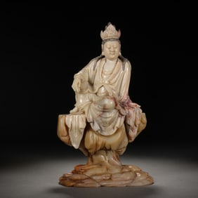 A CARVED SHOUSHAN STONE GUANYIN