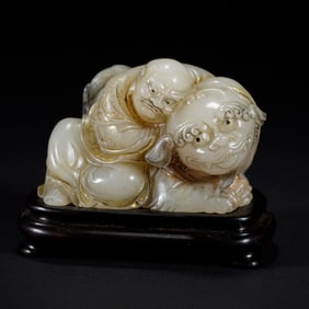 A CARVED JADE LUOHAN WITH BEAST