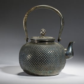A SILVER TEAPOT