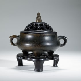 A BRONZE TRIPOD CENSER
