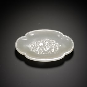 A CARVED WHITE JADE WASHER