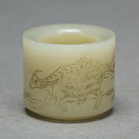 A CARVED WHITE JADE ARCHER RING