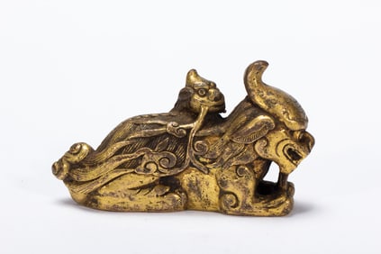 A BRONZE-GILT MYTHICAL BEASTS GROUP