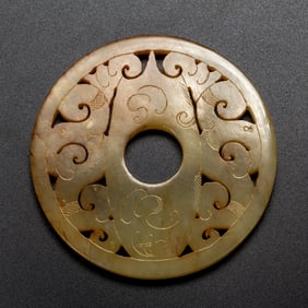 A CARVED AND RETICULATED JADE PLAQUE SHE
