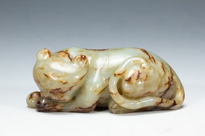 A CARVED WHITE JADE TIGER