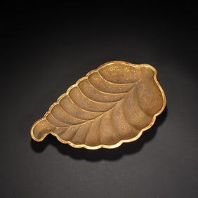 A BRONZE-GILT LEAF FORM WASHER