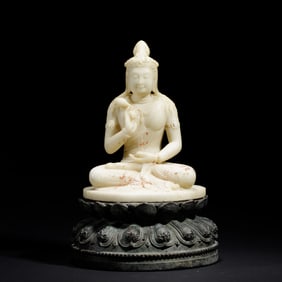 A CARVED MARBLE SEATED BODHISATTVA