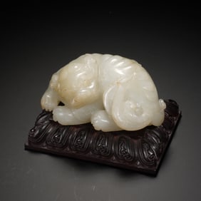 A CARVED WHITE JADE TIGER