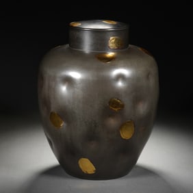 A TIN TEA CADDY WITH COVER