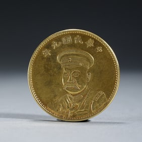A CHINESE SILVER-GILT COIN