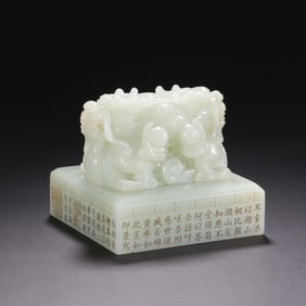 A FINE CARVED AND INSCRIBED WHITE JADE DRAGON SEAL