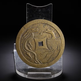 A BRONZE DRAGON AND PHOENIX COIN