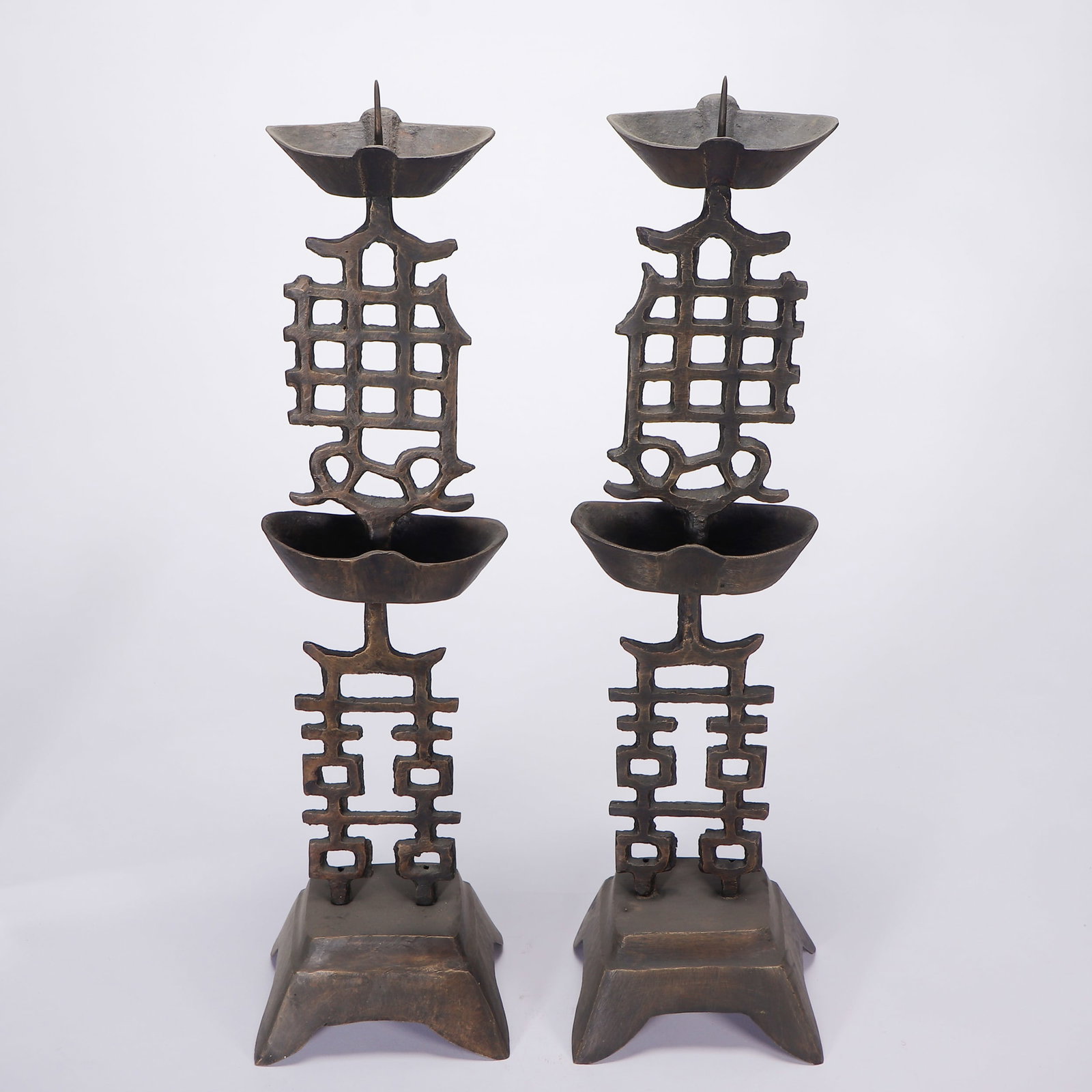 PAIR BRONZE HAPPINESS CANDLESTICKS: PAIR BRONZE HAPPINESS CANDLESTICKS Shown raised on rectangular bases and holding silver ingot-shaped drip pans. Dimension: H. 48 cm.
