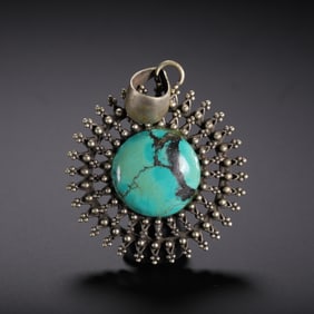 A TURQUOISE INLAID PENDANT
