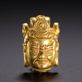 A GOLD HEAD OF GUARDIAN