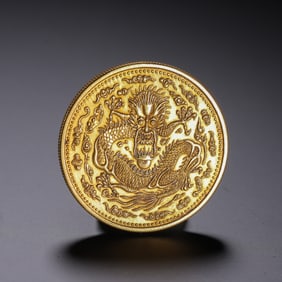 A CHINESE SILVER-GILT DRAGON COIN