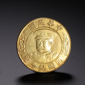 A CHINESE SILVER-GILT COIN