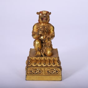 A TIBETAN BRONZE-GILT MYTHICAL BEAST PROTECTOR