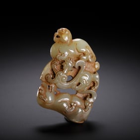 A CARVED CELADON JADE MYTHICAL BEASTS PENDANT
