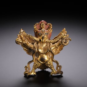 A BRONZE-GILT STANDING GARUDA
