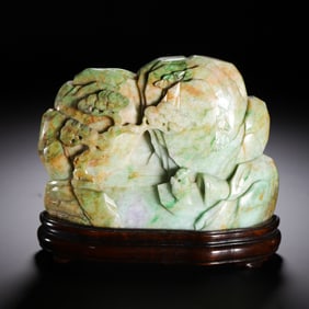A CARVED JADEITE BOULDER