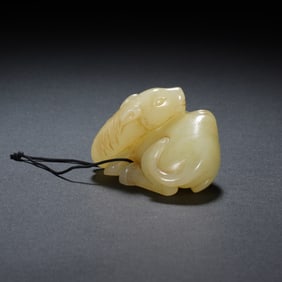 A CARVED YELLOW JADE MYTHICAL BEAST