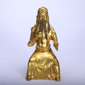 A BRONZE-GILT SEATED GUANDI