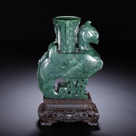 A CARVED SPINACH GREEN JADE MYTHICAL BIRD VESSEL