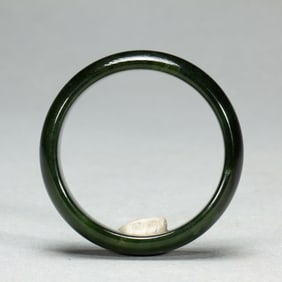 A SPINACH GREEN JADE BANGLE