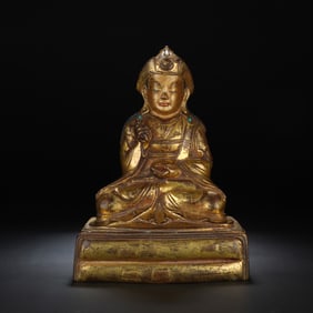 A BRONZE-GILT SEATED PADMASAMBHAVA